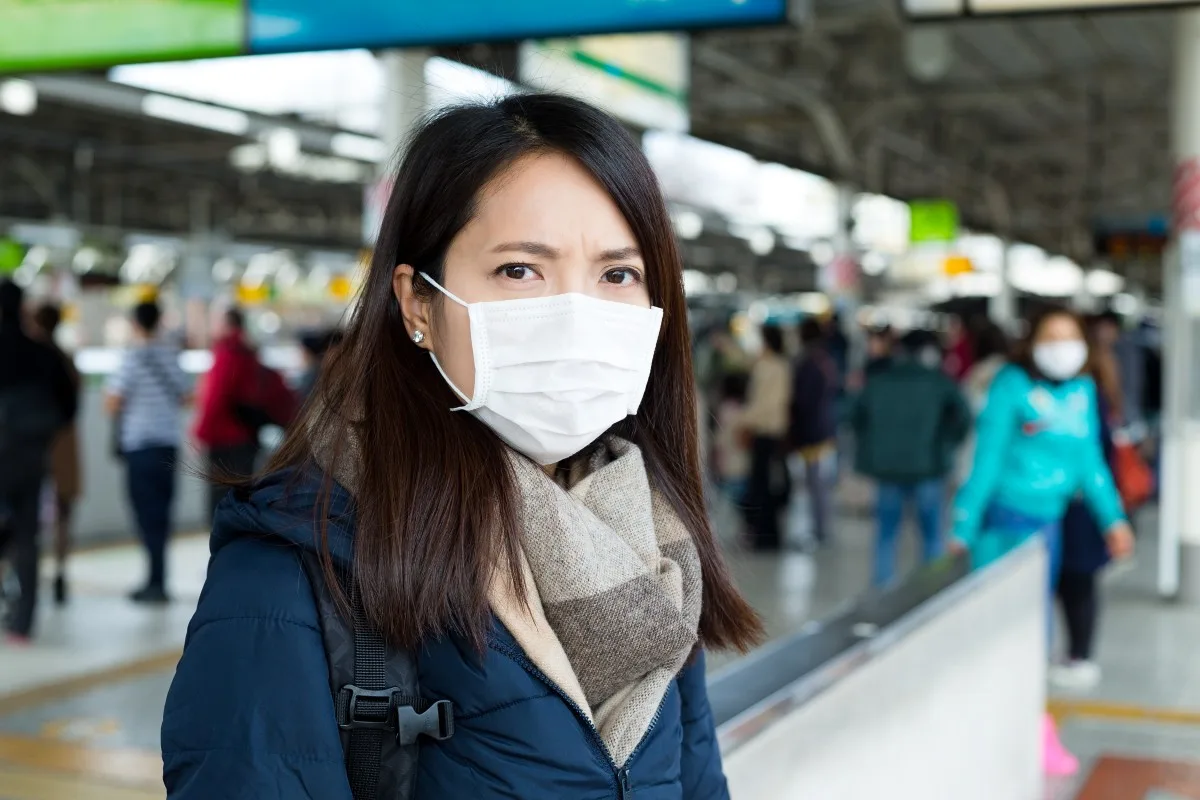 woman wearing face mask at train station