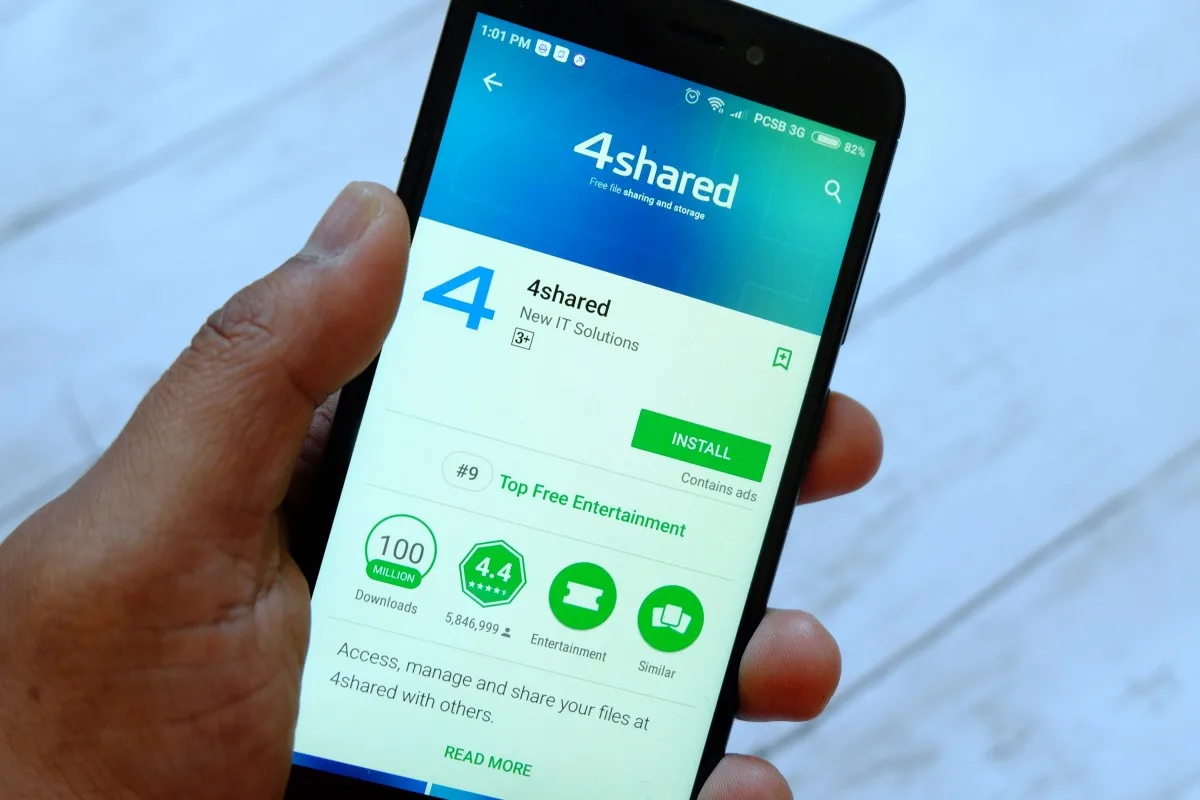 BANDAR SERI BEGAWAN,BRUNEI - JULY 25TH,2018 : A male hand holding smartphone with 4shared apps on an android Google Play Store
