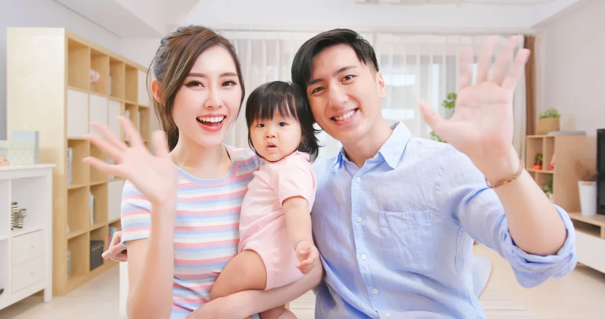 asian young couple and their daughter have video chat by webcam happily