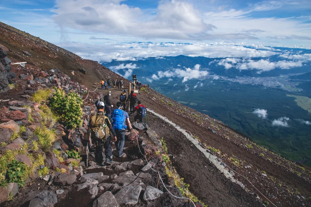 A Japan -Tourists descend from Mount Fuji along the Yoshida trail.