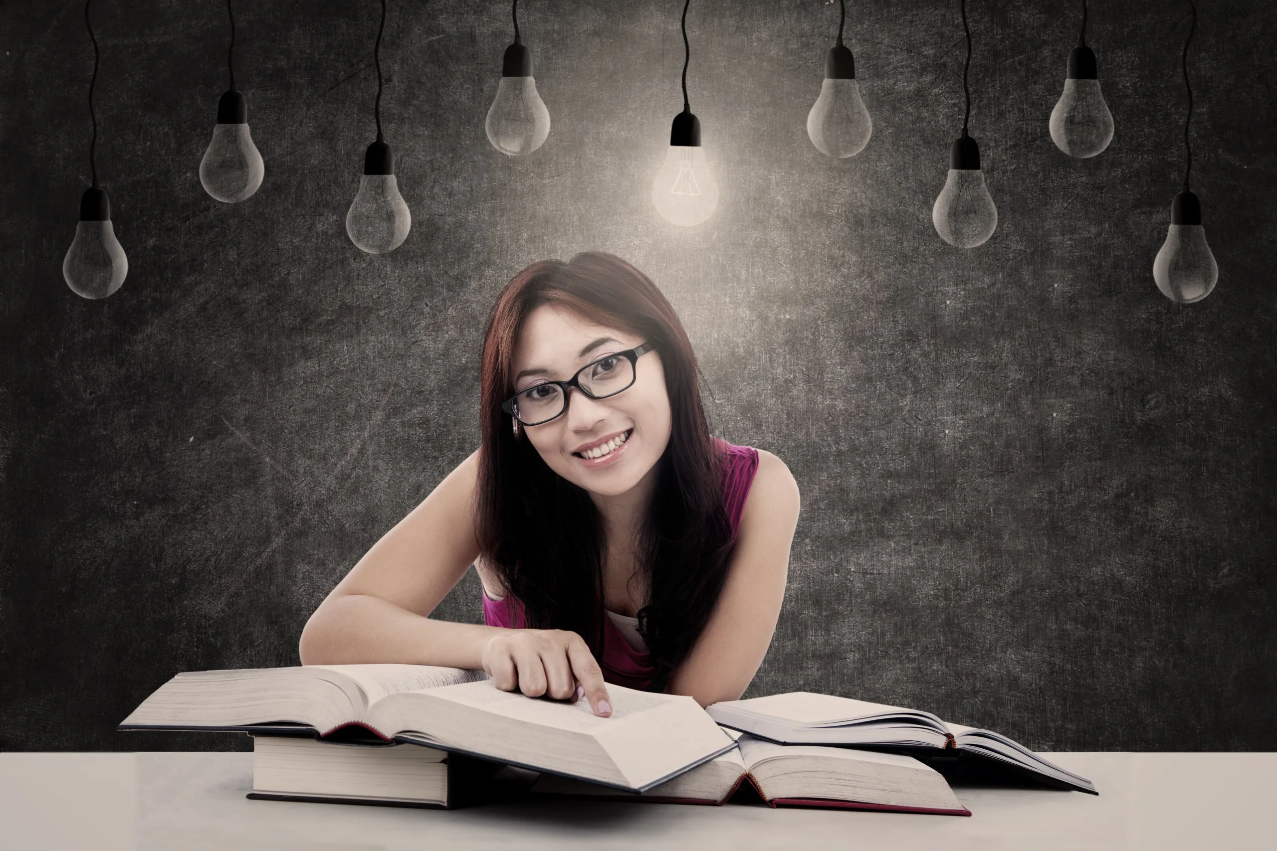 Happy student with lit bulb
