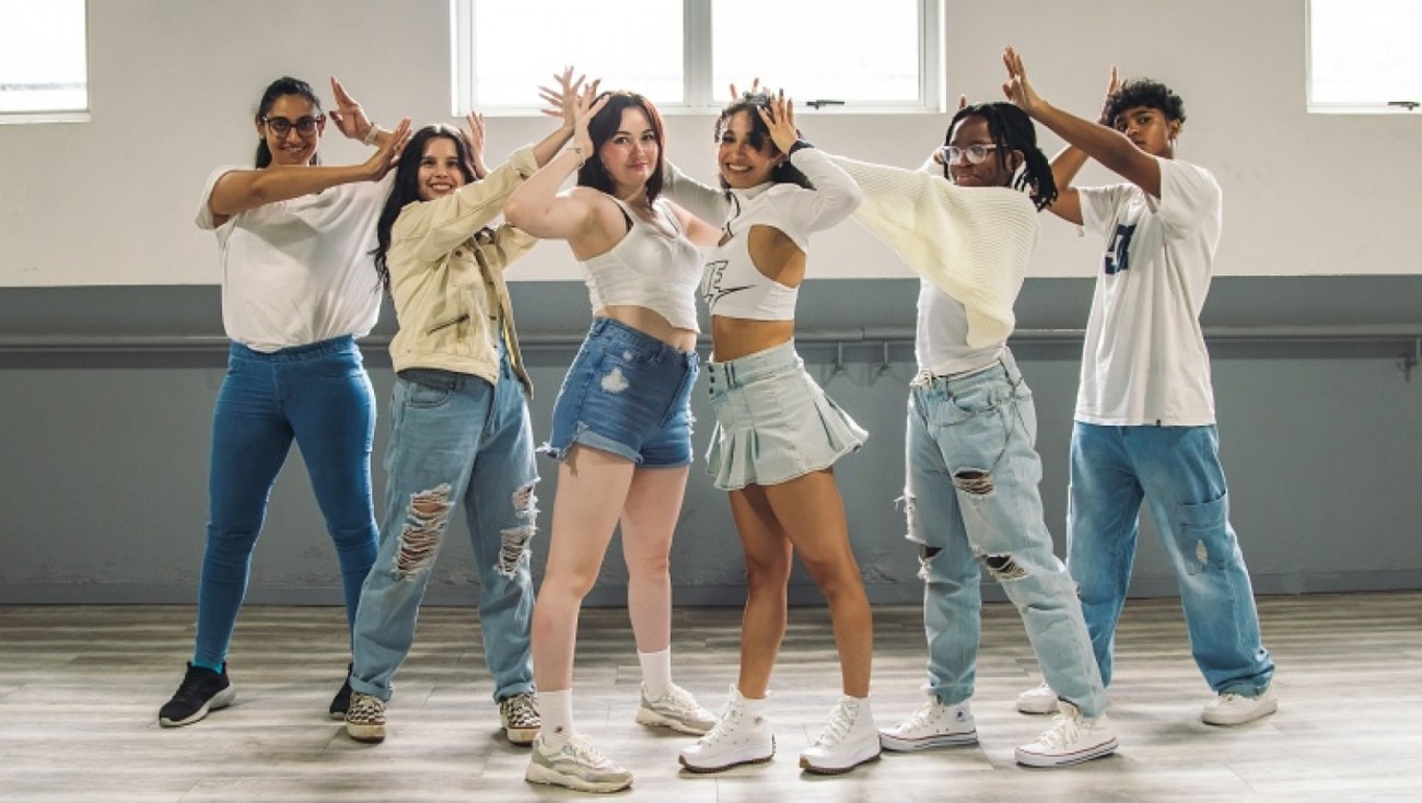 K-Pop group in a synchronized formation on stage